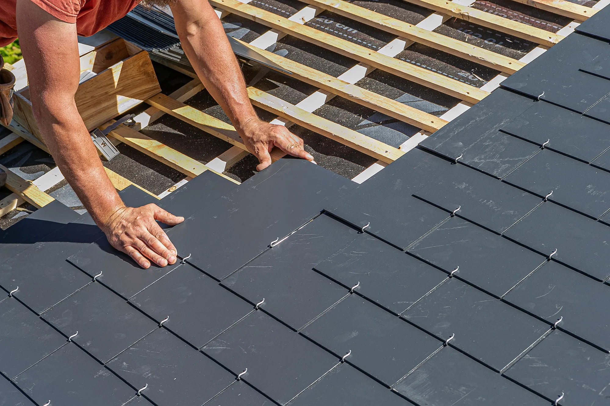 a man working on the roof of a house